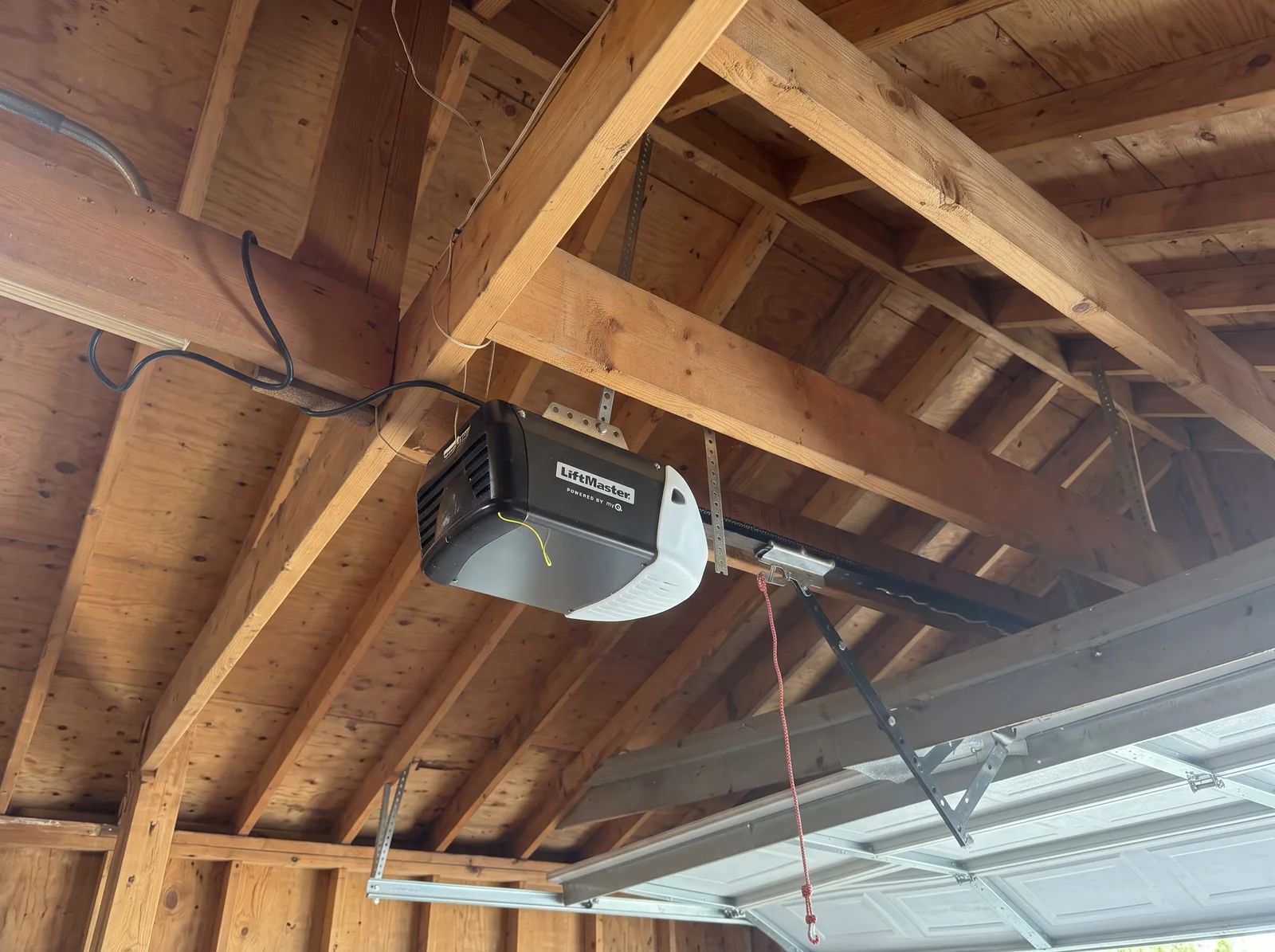 Garage door opener mounted beneath exposed timber framing