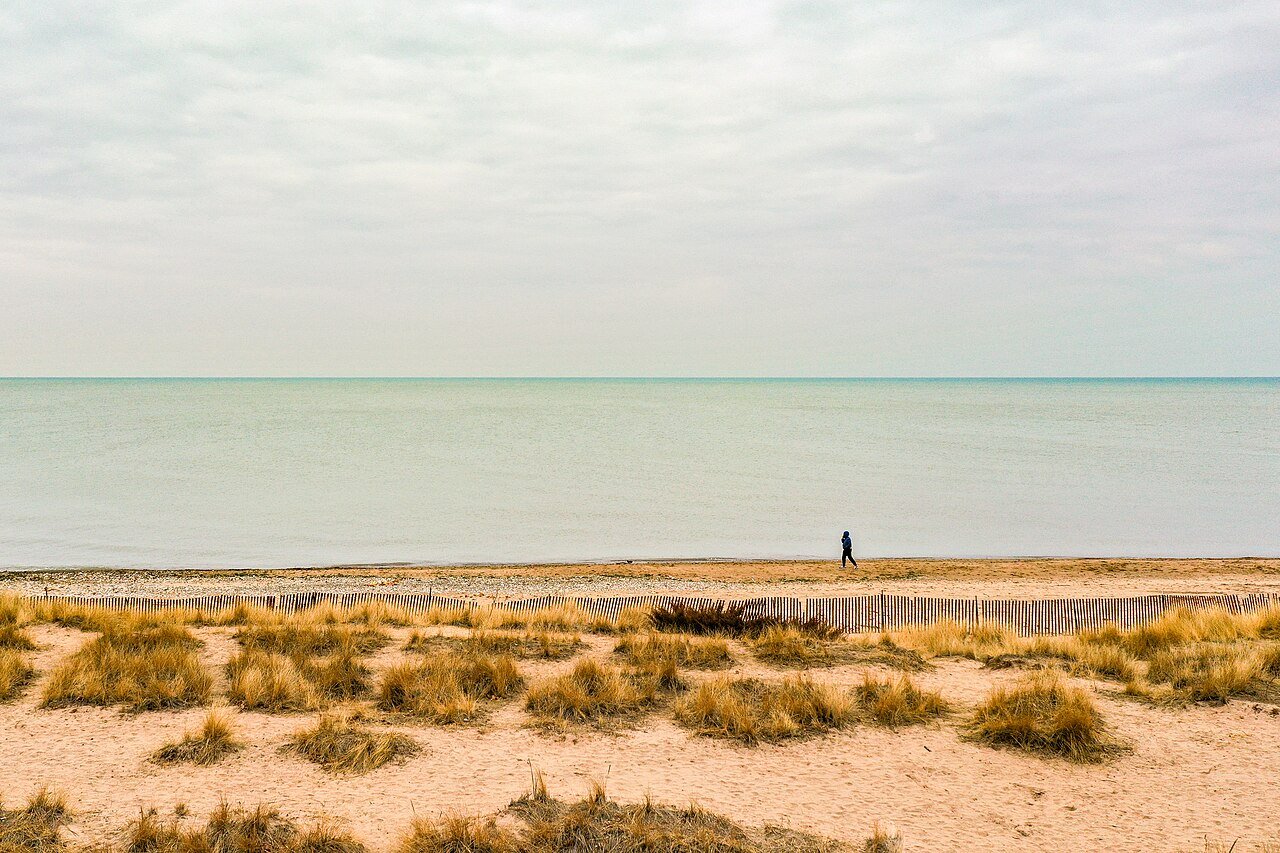 Grass-covered dunes and the sandy shoreline beside Lake Michigan at Lighthouse Beach in Evanston.