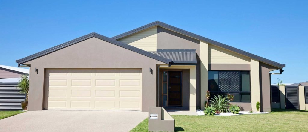 Modern home with a single sectional garage door and driveway