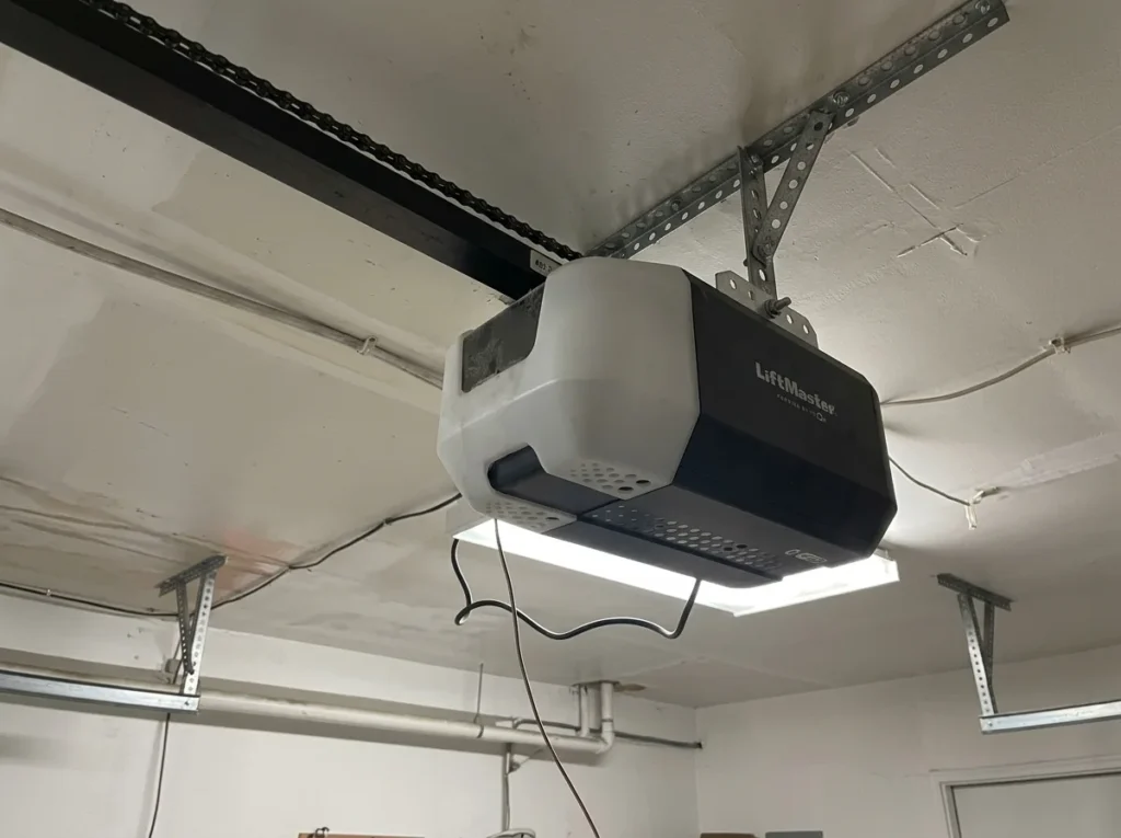 Ceiling-mounted garage door opener and rail